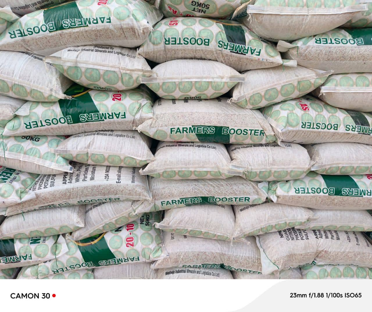Stacked 50kg Silver Green Farmers Booster fertilizer bags in the warehouse